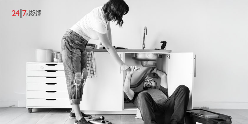 couple attempting DIY fix to kitchen sink