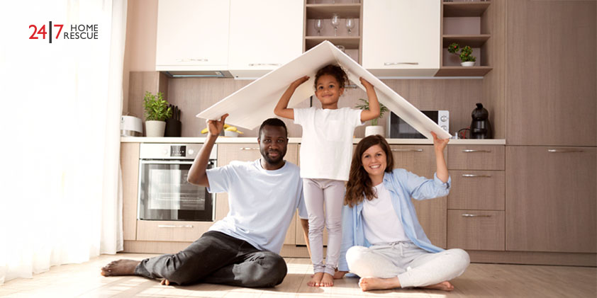 cute family holding a roof above their head