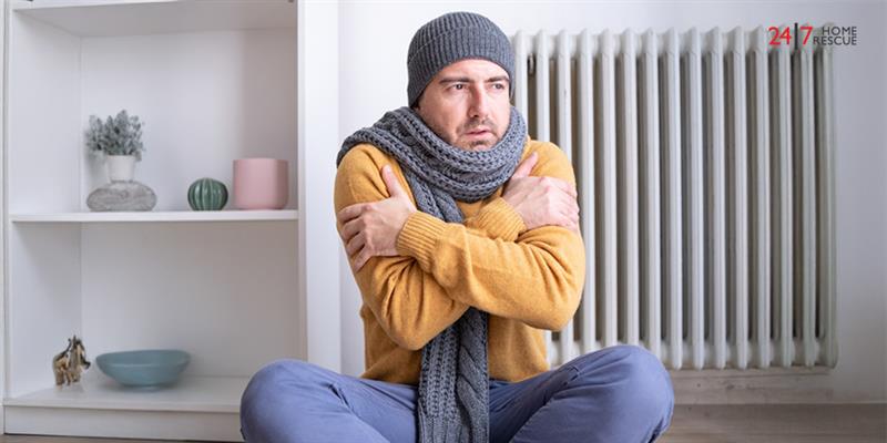 Person suffering cold inside house caused by heating problem