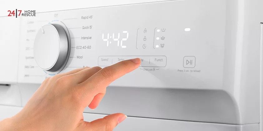 Lady's Hand Touching The Washing Machine Control Panel