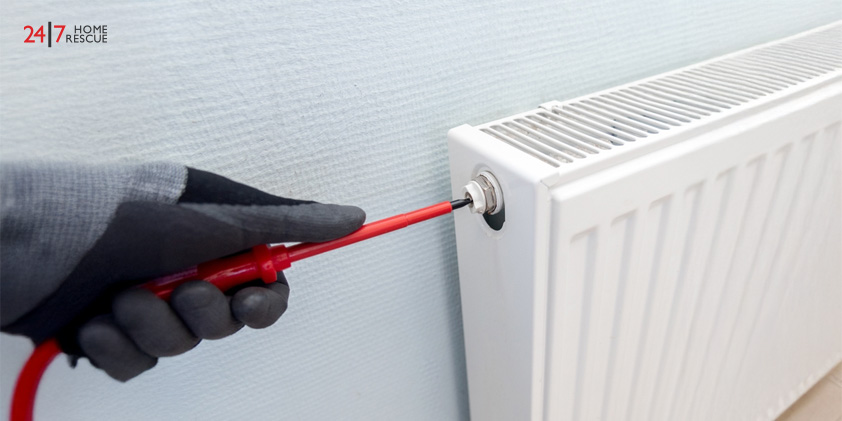 Radiator bleeding process by a professional heating engineer