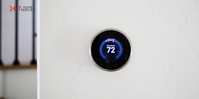 Wall-mounted smart thermostat displaying temperature setting