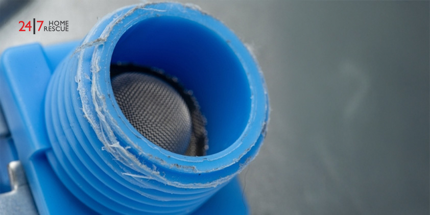 Close-up view of a dishwasher fill valve with a plastic inlet damaged due to cross-threading