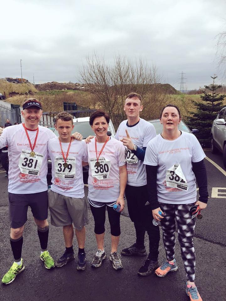 The 24|7 Home Rescue amateur runners proudly show off their medals after the race