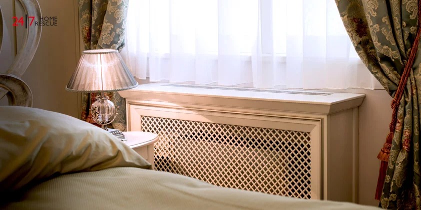 A Bed With a Lamp on The Side With a Radiator Cover
