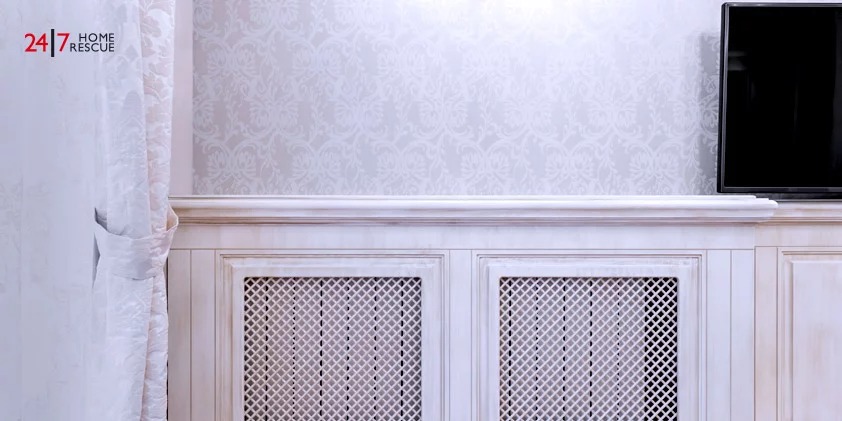 A White Wall With a Radiator Cover