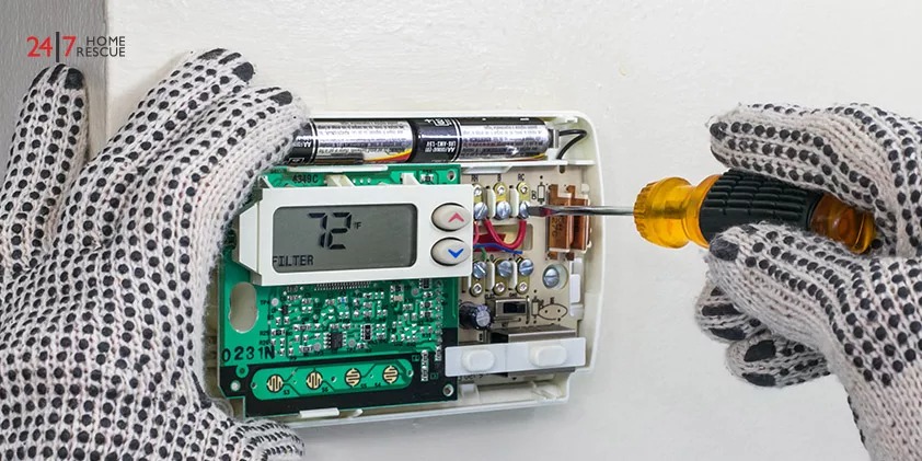 An Engineer is Cleaning Thermostat