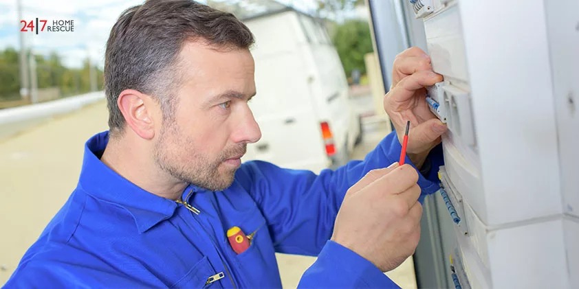 An engineer is checking the blown fuse