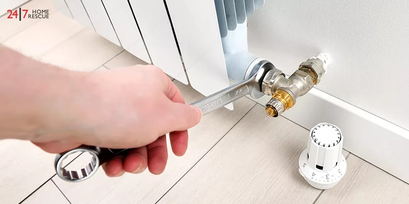 Loosening the radiator with the spanner