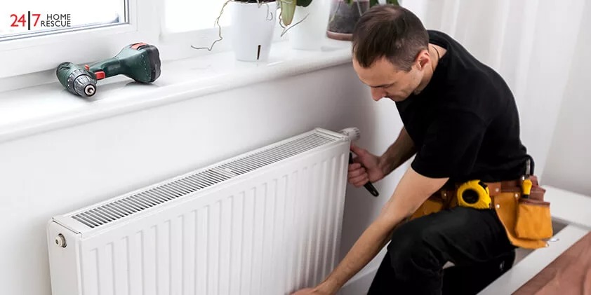 A man is removing a radiator