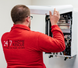 A 24|7 home rescue engineer is checking a boiler