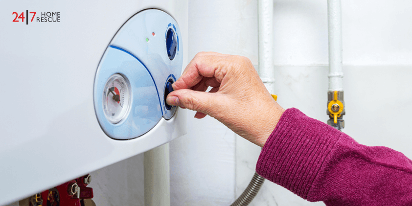 A person is switching off the boiler