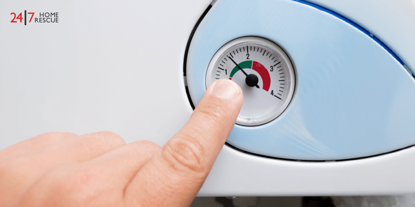 A person is locating the pressure gauge in the boiler