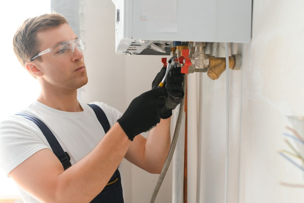 Gas safe engineer inspecting a boiler