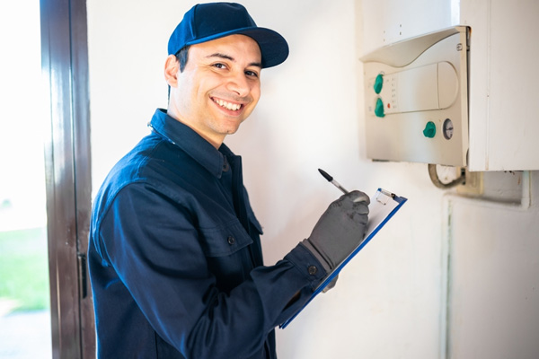Happy boiler engineer with a checklist on his hands