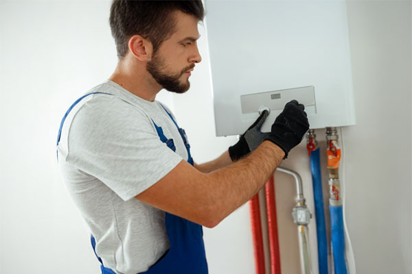 Engineer  setting the new gas boiler for hot water and heating