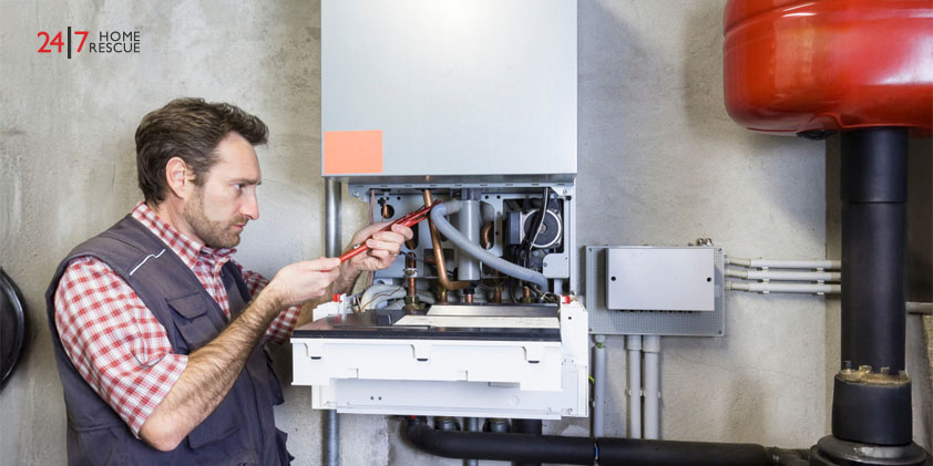 plumber repairing a condensing boiler