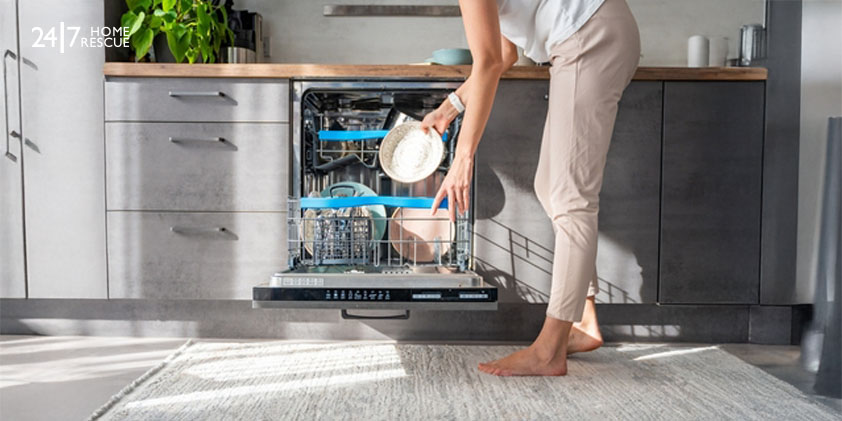 Woman removes clean ceramic dishes from dishwasher