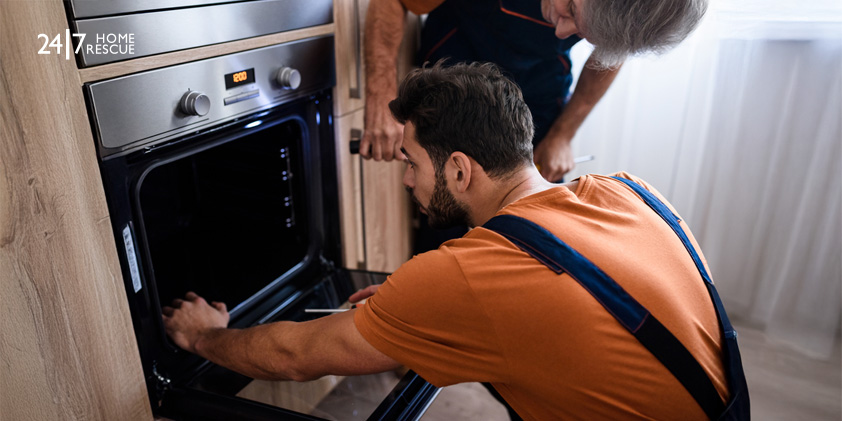 Repairmen inspecting an oven with tools to find out why it is not heating up