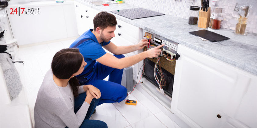 Technician checks dishwasher with a multimeter for a drainage issue