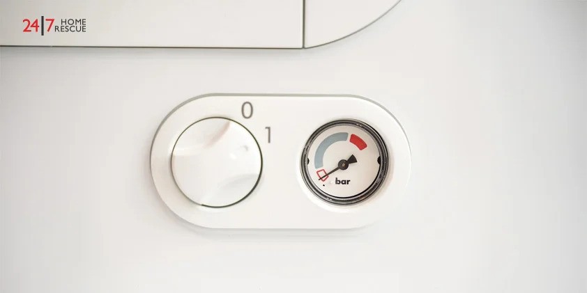 close up of an residential boiler's control and pressure guage