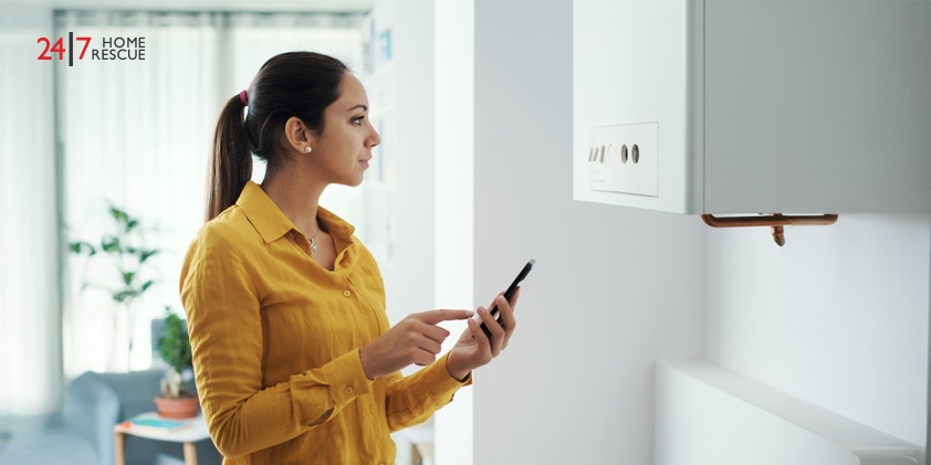 Woman managing and programming her smart boiler using her smartphone