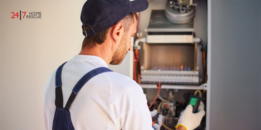 Engineer adjusting ionisation probe in gas boiler to restore reliable flame detection