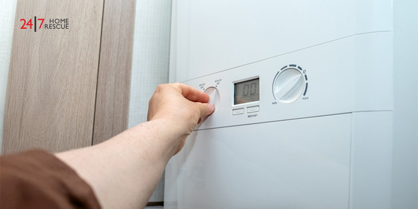 Person adjusting boiler temperature