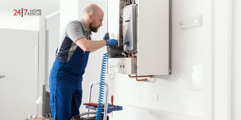 Gas engineer checking and cleaning a boiler during the inspection at home
