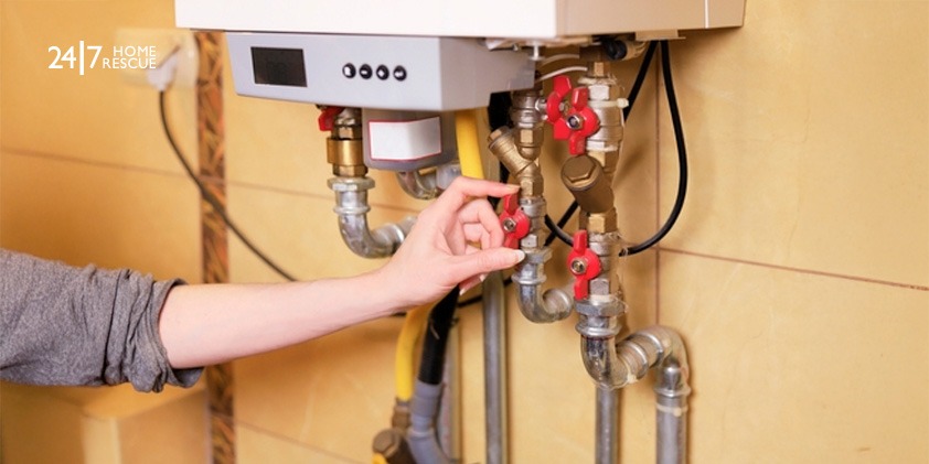 Woman checking the gas valve of a boiler