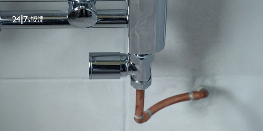 A picture showing a lockshield valve on a chrome radiator boiler.
