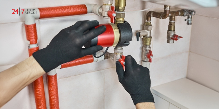 An engineer repairing a heating system's circulation pump