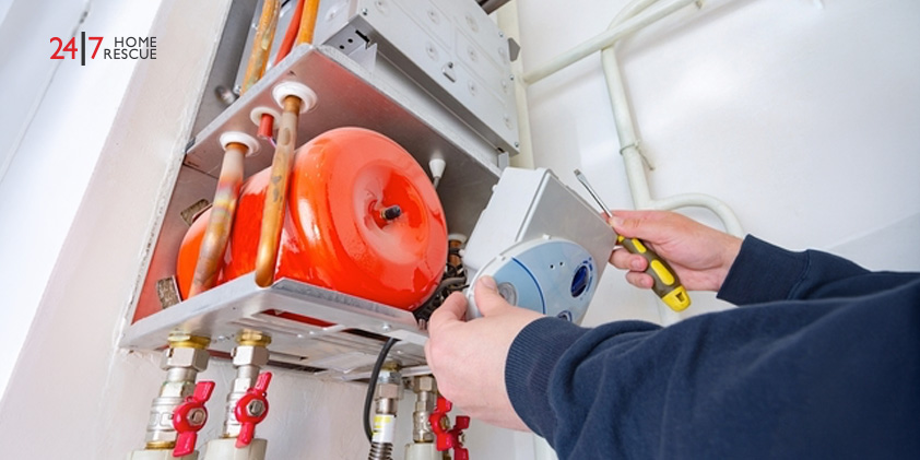 Close-up of a heating engineer repairing and inspecting the internal components of a domestic boiler