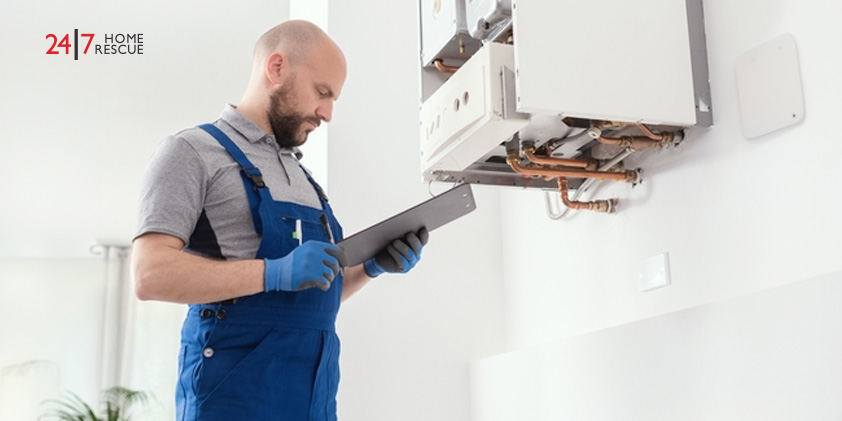 Professional boiler engineer carrying out an annual gas boiler service and safety inspection