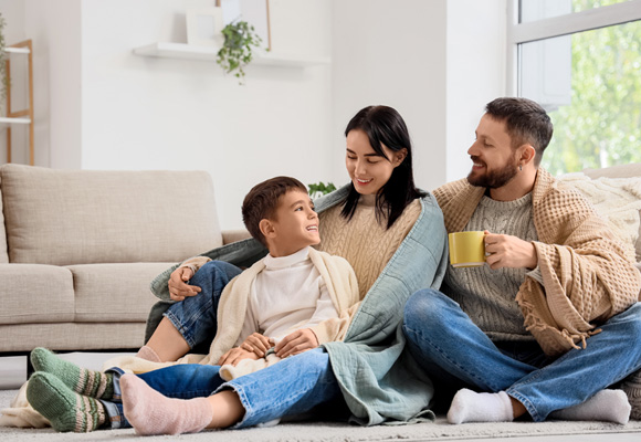 Family wrapped in blankets enjoying a warm home