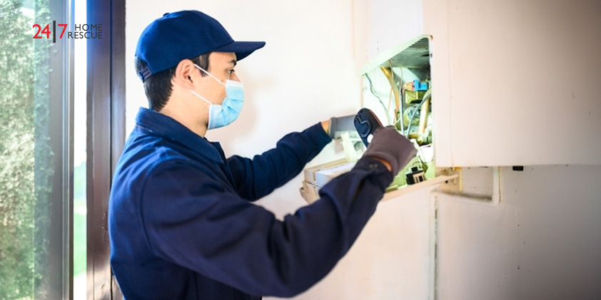 Gas boiler being serviced by engineer