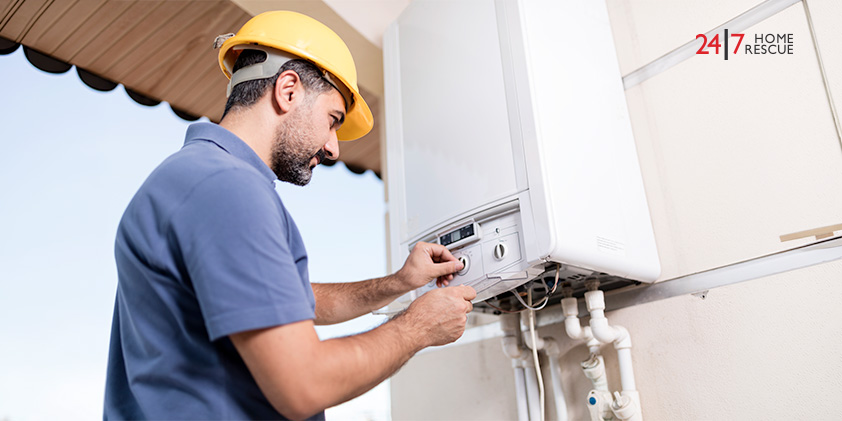 Engineer repairing wall-mounted boiler